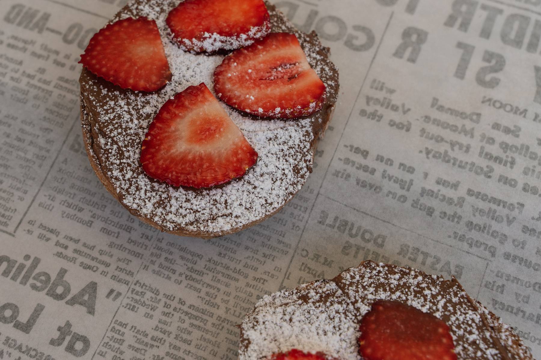 Open Nutella bagel with strawberries